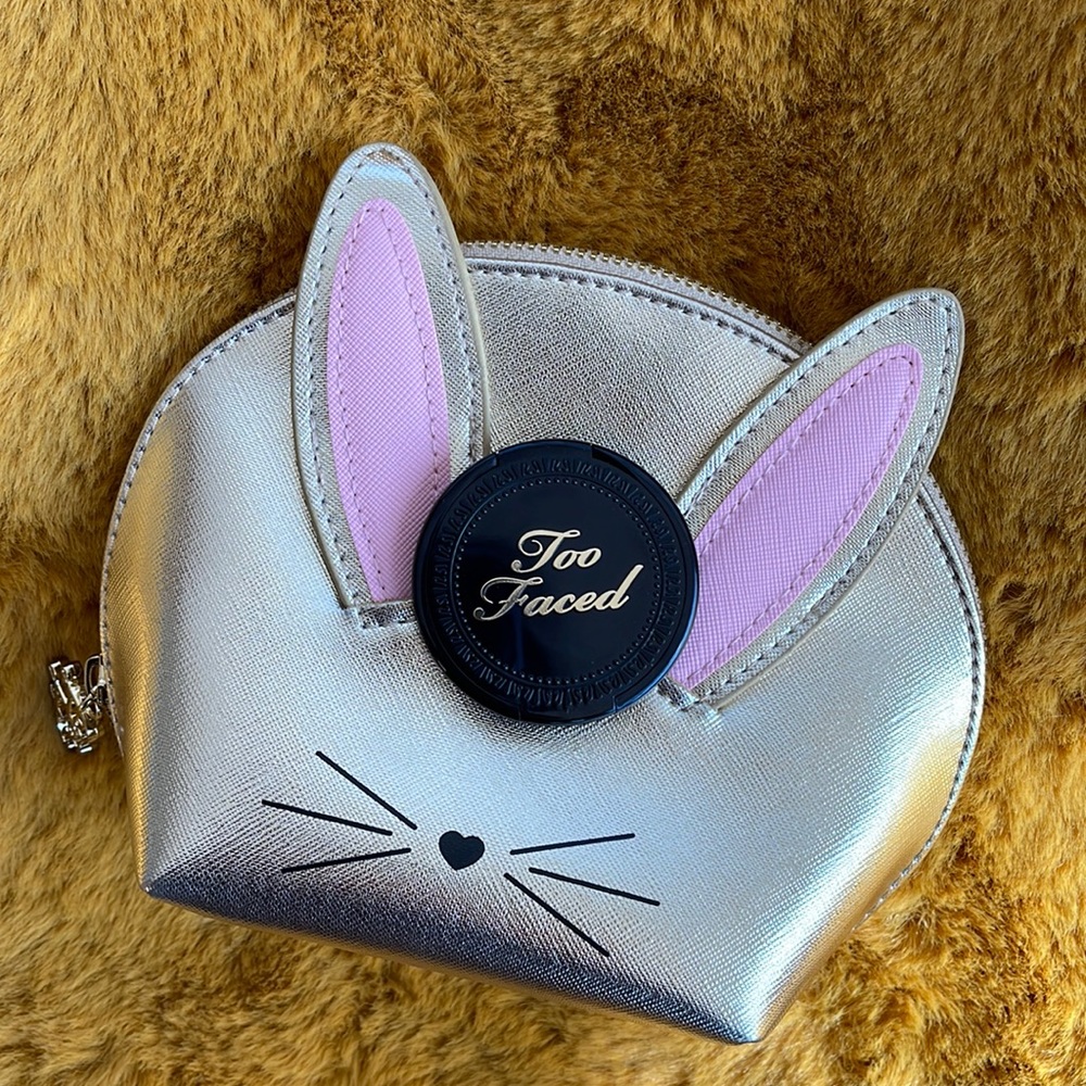 Too faced bronzer and cosmetic bag.